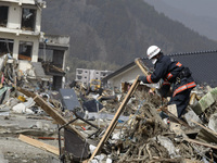 March 20, 2011-Rikuzen Takata, Japan-Rescue Team searching operation on debris and mud covered at Tsunami hit Destroyed city in Rikuzentakat...