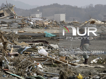 March 20, 2011-Rikuzen Takata, Japan-Native Survivors find their house lot on debris and mud covered at Tsunami hit Destroyed city in Rikuze...