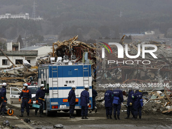 March 20, 2011-Rikuzen Takata, Japan-Rescue Team searching exhume body on debris and mud covered at Tsunami hit Destroyed city in Rikuzentak...