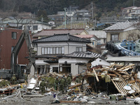 March 21, 2011-Ofunato, Japan-Military searching exhume body to debris and mud covered at Tsunami hit Destroyed Industrial Area in Ofunato o...