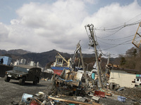 March 25, 2011-Kamaishi, Japan-Military vehicle patrol around on debris and mud covered at Tsunami hit Destroyed mine town in Kamaishi on Ma...
