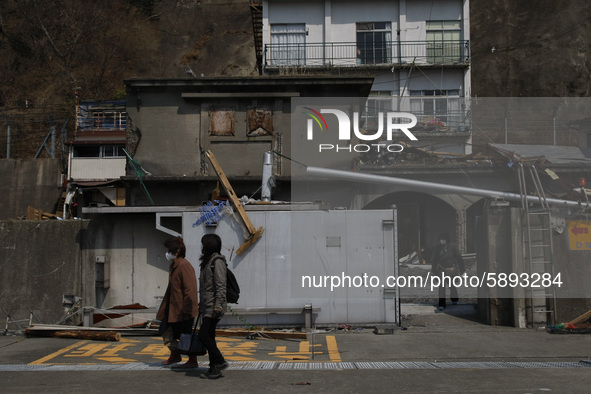 March 25, 2011-Kamaishi, Japan-Native Survivors leaving their house on debris and mud covered at Tsunami hit Destroyed mine town in Kamaishi...