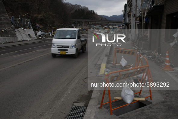 March 25, 2011-Kamaishi, Japan-Vehicle ride repair road on debris and mud covered at Tsunami hit Destroyed mine town in Kamaishi on March 25...