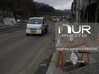 March 25, 2011-Kamaishi, Japan-Vehicle ride repair road on debris and mud covered at Tsunami hit Destroyed mine town in Kamaishi on March 25...