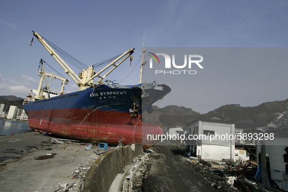 March 25, 2011-Kamaishi, Japan-The Ship 'Asia Symphony'  strand after lift up the promenade of dock near debris and mud covered at Tsunami h...