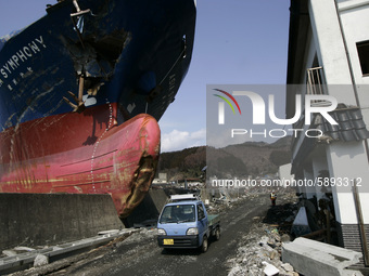 March 25, 2011-Kamaishi, Japan-The Ship 'Asia Symphony'  strand after lift up the promenade of dock near debris and mud covered at Tsunami h...