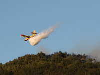 Canadair at work to extinguish a huge fire near L'Aquila, Abruzzo (italy) on July 31, 2020. A large fire, the second in two days, is burning...