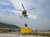 The Canadairs and the Civil Protection and Carabinieri Corps helicopters launch water over the vast fire, L'Aquila, Italy, on August 1, 2020...