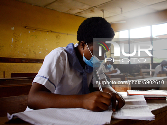High School students wears a face mask while they reads in a classroom at Ireti Junior Grammar Schol, Ikoyi, Lagos on August 3, 2020 on the...