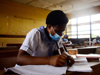 High School students wears a face mask while they reads in a classroom at Ireti Junior Grammar Schol, Ikoyi, Lagos on August 3, 2020 on the...