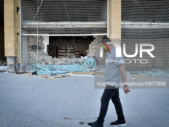 A man walks near a damaged building, the day after a massive explosion at the port on August 5, 2020 in Beirut, Lebanon. According to the Le...