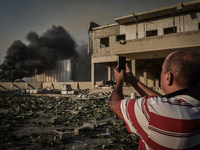 A man takes a picture at the port after the explosion on August 4, 2020 in Beirut, Lebanon. According to the Lebanese Red Cross, at the mome...