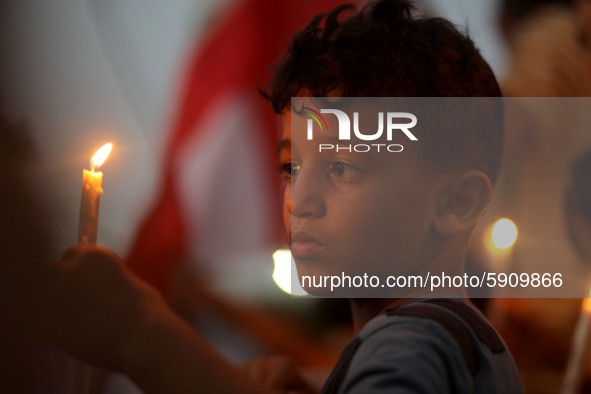 Palestinians light candles to show solidarity with the Lebanese people following the huge explosions in Beirut's port area, in Gaza City, on...