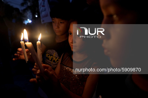 Palestinians light candles to show solidarity with the Lebanese people following the huge explosions in Beirut's port area, in Gaza City, on...