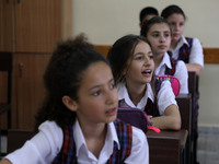 Palestinian schoolchildren sit inside a classroom in the rosary sisters school gaza , on the first day of a new school year, as Palestinians...