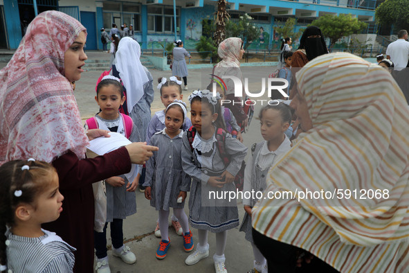 Women bring their children to the United-Nation run Elementary School on the first day of the new school year as Palestinians ease the coron...