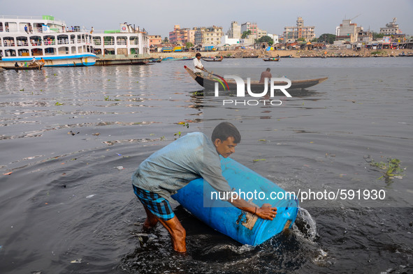 May 17, 2015 - Dhaka, Bangladesh - A man washing a plastic drum which had been used to carry toxic chemicals. 