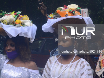 Worshipers of river goddess Osun carries sacrifices on a tray on their heads during the traditional town cleansing procession at the start o...
