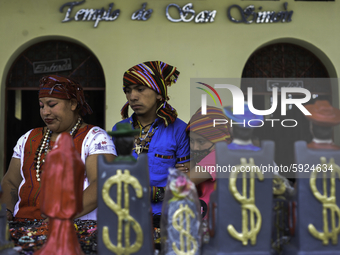 Indigenous people buy objects of the saint Maximon in the temple of San Simón in San Andrés Itzapa, 50 kilometers west of the capital city o...