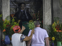 A couple asks Santo Simon for money and work at the temple of San Andrés Itzapa, 50 kilometers west of Guatemala's capital, on August 14, 20...