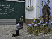 Guatemalan parishioners pray outside the Church of the Assumption in zone 2 of Guatemala City, on August 15, 2020, in honor of the Virgin of...