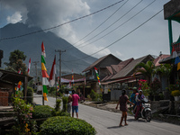 People doing activities after the eruption rained volcanic ash a week ago at Payung Desa, on August 17, 2020, in Karo Regency, North Sumatra...