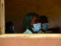 The final year students of Babs Fafunwa Millennium Senior Grammar School, Ojodu, Lagos, Nigeria sit with facemasks in a classroom as they wa...