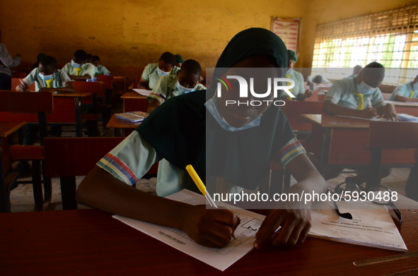 The final year students of Babs Fafunwa Millennium Senior Grammar School, Ojodu, Lagos, Nigeria sit with facemasks in a classroom as they co...