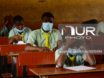 The final year students of Babs Fafunwa Millennium Senior Grammar School, Ojodu, Lagos, Nigeria sit with facemasks in a classroom as they co...