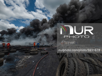 Firefighters try to extinguish fire at a out  tire factory in Pekanbaru, Riau Province, Indonesia, on August 18, 2020. No casualties were re...