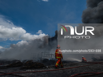 Firefighters try to extinguish fire at a out  tire factory in Pekanbaru, Riau Province, Indonesia, on August 18, 2020. No casualties were re...