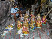 A seller waits for customer at a potters hub in Kolkata.Ganesh chaturthi or Ganesh puja is the Hindu festival of celebrating the arrival of...