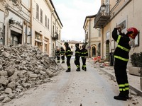 A fireman ltakes a photo at a destroyed houses in Norcia, Italy, Italy, on November 1, 2016.  (