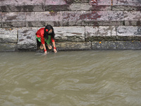 A Little girl offer ritual prayer in the Bank of Bagmati River during Teej festival celebrations at Kathmandu, Nepal on Friday, August 21, 2...