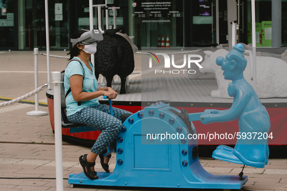 a visitor tries out a VR simulation of  carnival kids ride at places - VR festival in Gelsenkirchen, Germany, on August 21, 2020.  