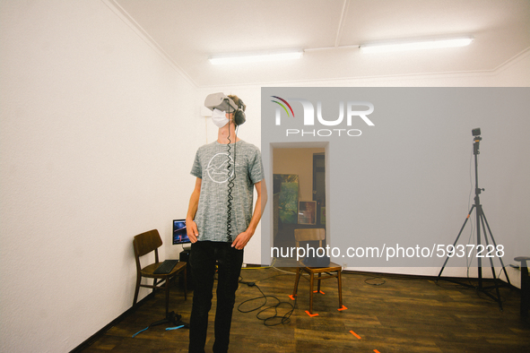 a visitor with a face mask experiences VR in a small studio at places-Visual reality festival in Gelsenkirchen, Germany, on August 21, 2020....