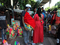 People buy idols of the elephant-headed Hindu deity Lord Ganesh ahead of beginning the Ganesh Chaturthi festival starting from today at Karo...