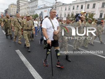 Ukrainian servicemen, veterans of the eastern Ukrainian conflict with Russia-backed separatists, attend an unofficial military parade called...