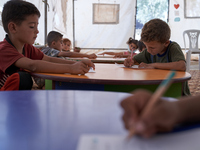 Syrian students take a math lesson in a refugee camp near Syrian-Turkish borders in Idlib, Syria, on August 25, 2020. (
