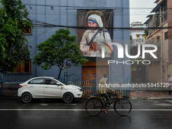 A large picture of Saint Teresa hangs outside the walls of Missionaries of Charity in Kolkata.This year marked the 110th year Birthday of Sa...