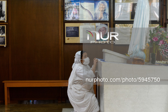 A nun offers her prayer to the tomb of Saint Teresa at Mother house in Kolkata.A lady pray in front of a picture of Saint Teresa , outside M...