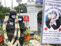 A view of the statue of Mother Teresa with a mask, during an event for celebrate the 110th birth anniversary of St. Teresa, in Kolkata, Indi...