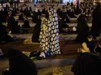 An Iranian Shi’ite mourner prays while attending a Moharram religious ceremony in the Imam Hussein square in southern Tehran on August 25, 2...