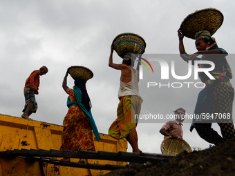 Day laborers unload sand from a cargo ship in Dhaka, Bangladesh on August 26, 2020. Dhaka is getting back to its normal life after months of...