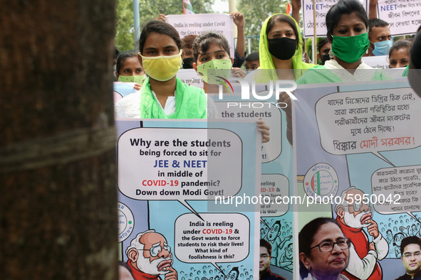 Students and Member of Trinamool Congress Chharta Parisad (TMCP) holds posters during a protest against the Union Government conducting JEE...