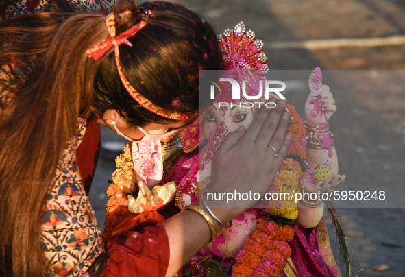 A devotee whispers a wish in the ear of an idol of Hindu deity Ganesha, as part of a ritual on the occasion of Ganesha Chaturthi, before imm...