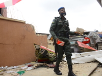 A police officer walk amidst debris of a Quorom helicopter crash, a helicopter operated by Quorom Aviation which crashed in 16A Salvation Ro...