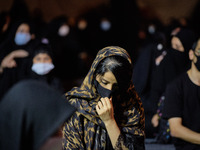An Iranian Shi’ite Muslim wearing a protective face mask attends a Muharram mourning ceremony in southern Tehran on August 28, 2020. The new...
