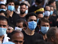 Shiite Muslim mourners wear face masks as they take part in the Muharram Processions during the Islamic month of Muharram ahead of Ashura ce...