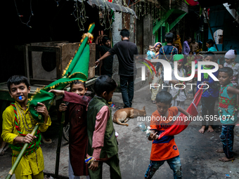 Young Biharis carry flying banners and play with them inside the geneva camp in Dhaka, Bangladesh, on August 29, 2020. (